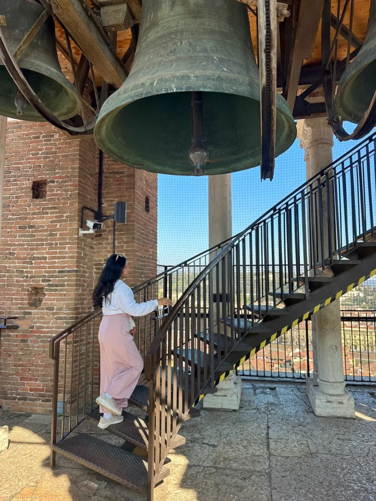Historic bells inside Torre dei Lamberti tower in Verona near the upper observation level.