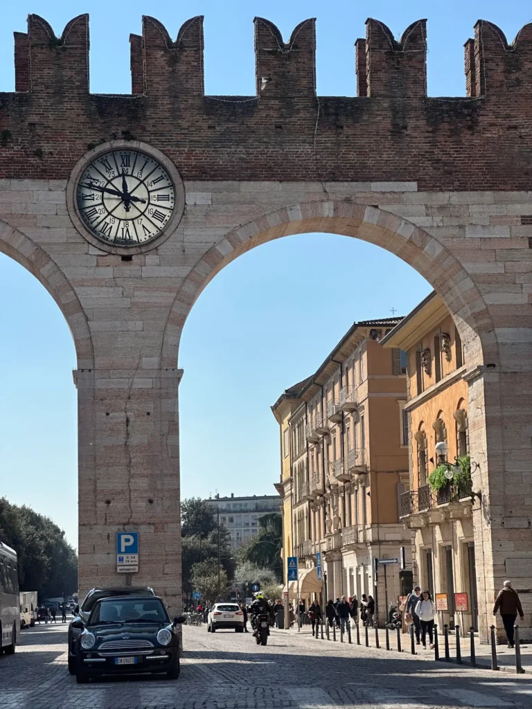 Verona piazza Portoni della Bra arch entrance with clock and historic walls