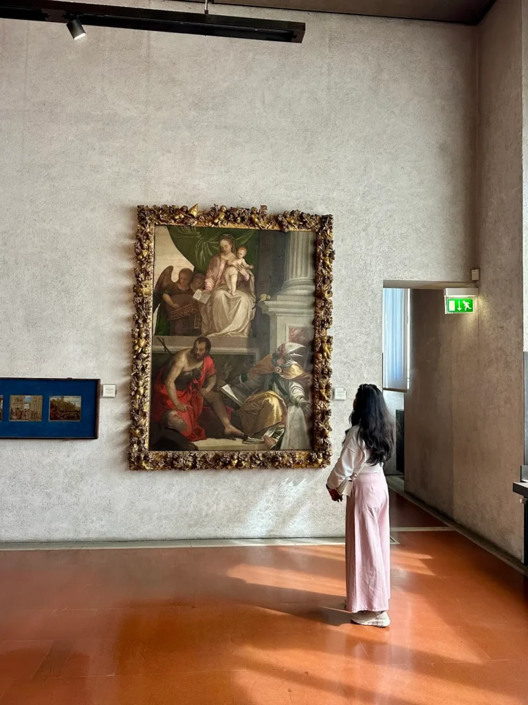 Castelvecchio Museum Verona Bevilacqua Lazise Altarpiece with a woman standing and observing the large framed painting.