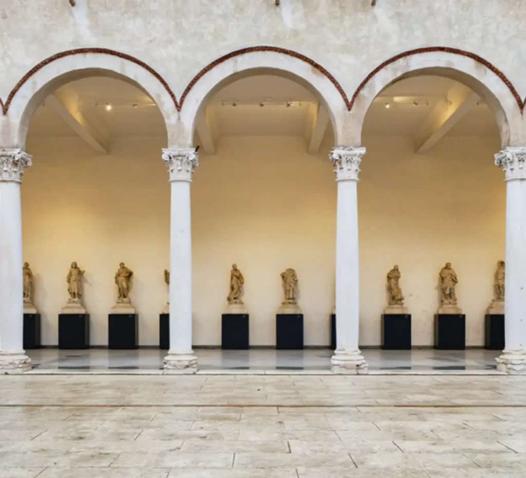 This image shows the elegant sculpture gallery of MACA (Museo di Arte e Cultura Antica) in Mantua, Italy.