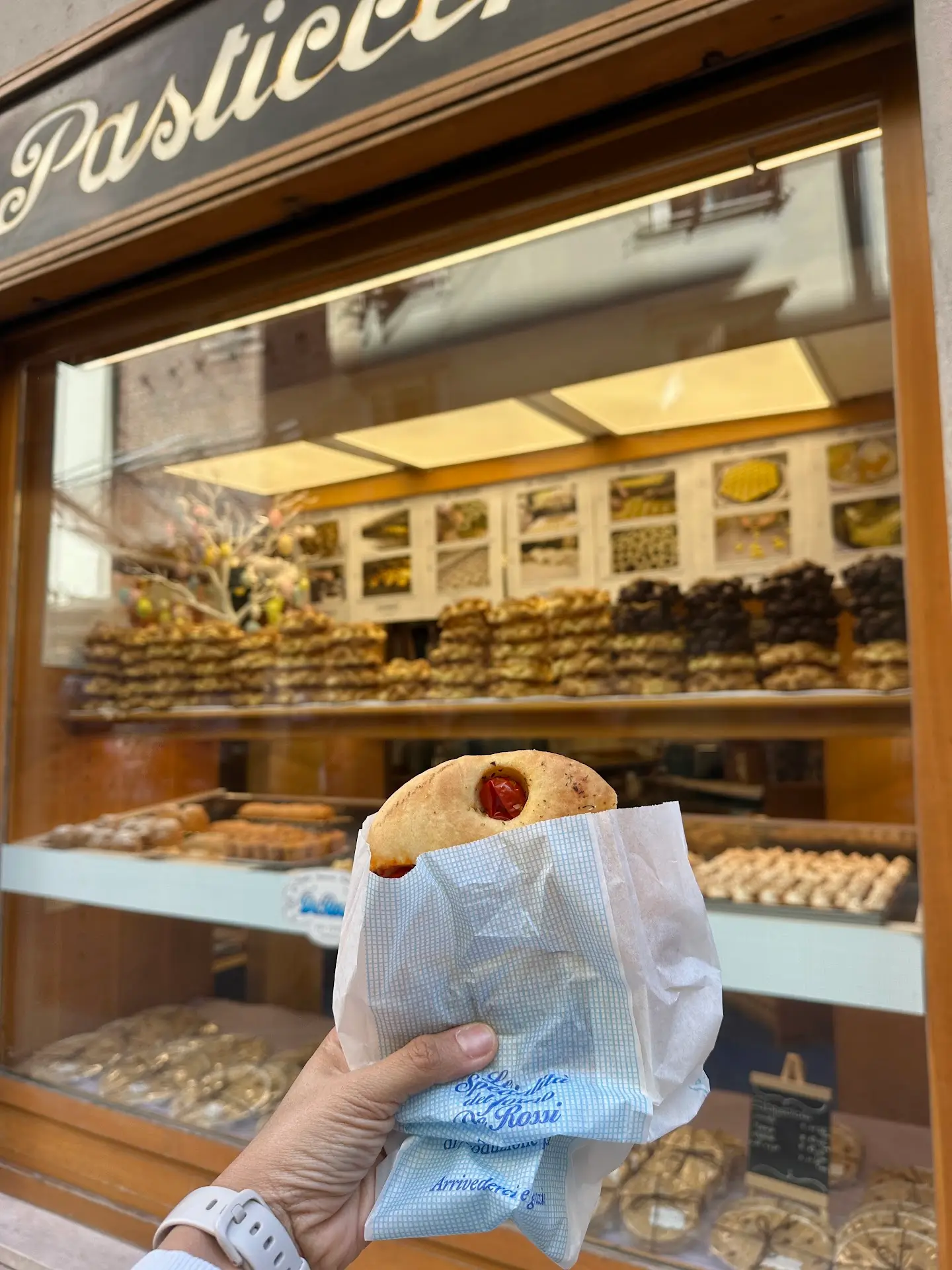 Italian pastry from a pasticceria in Verona held in front of bakery display – what to eat in Verona sweet treats
