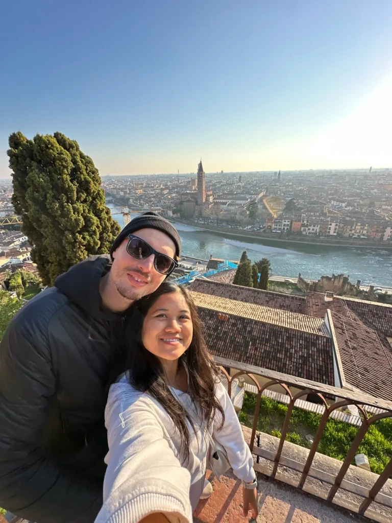 Castel San Pietro Verona viewpoint selfie overlooking Adige River, rooftops, and church towers